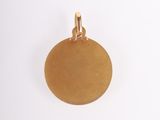 an image of a gold disc pendant on a white background