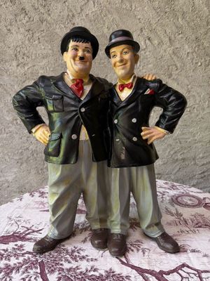 two figurines of two men standing next to each other