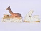 two figurines of animals that are sitting on top of each other