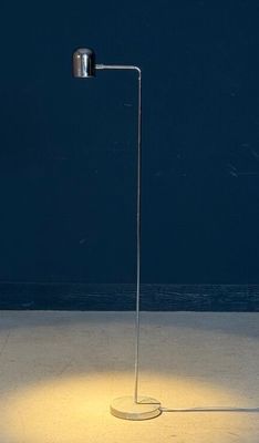 a floor lamp that is lit up on a concrete floor