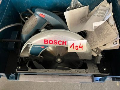 a bosch circular saw in a box with papers in it