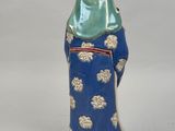 a figurine of a person wearing a blue robe