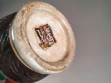 a close up of a bottle with a toothbrush in it