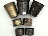a group of five silver and bronze napkin rings