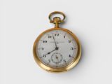 a gold pocket watch with a white face on a white surface