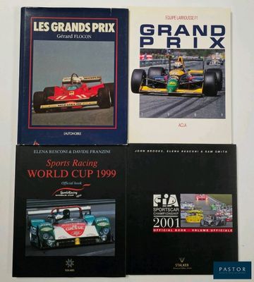 three books on a white surface with a picture of a racing car