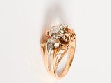 an image of a gold ring with a diamond center