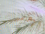 a bird that is sitting on a branch of a palm tree