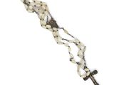 a close up of a rosary with a cross on a chain