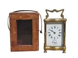 a small clock that is next to a small box