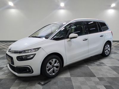 the white citrole is parked on a checkered tile floor
