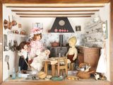 a doll house with dolls in it and a teddy bear in it