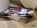 several baseball bats are in a cardboard box on a table