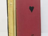 three books are stacked on top of each other with a heart cut out of them