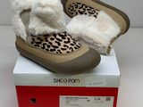 leopard print slippers with faux lining on top of a box