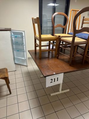 plusieurs chaises et une table dans une pièce équipée d'un réfrigérateur