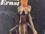 the cover of a magazine with an image of a woman sitting on a chair