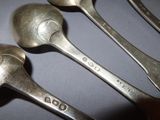 three spoons that are sitting on a table