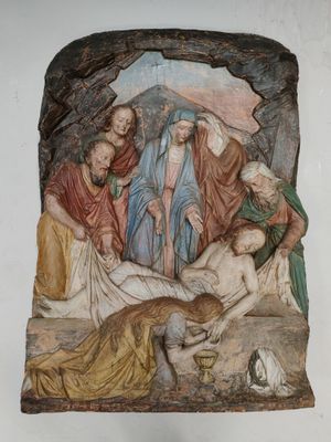 une image représentant un tableau où l'on voit Jésus allongé sur la croix dans une grotte
