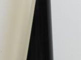 a black cone shaped object sitting on a wooden floor