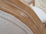 a close up of a wooden chair with a white seat