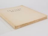 an old book sitting on top of a white table