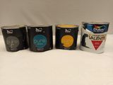 four cans of paint are lined up on a white surface