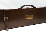 a brown suitcase with a handle on a white background