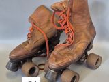 a pair of old roller skates with wheels and laces
