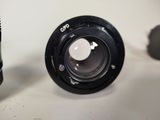 a camera lens sitting next to a camera lens on a table