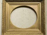 a gold picture frame with a white background