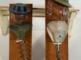 two bottle openers with hats on them sitting on a table