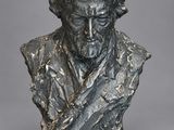 a bronze bust of a man with a long beard