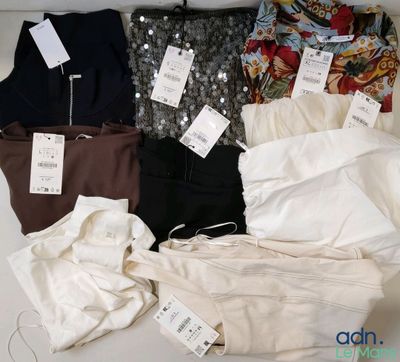 a lot of clothes that are sitting on a table