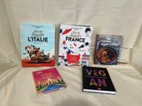 many books that are sitting on a bed together