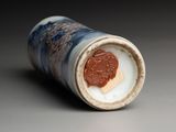 a close up of a small vase with a coin in it