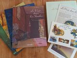 several books on a table with a wooden table top
