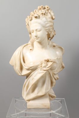 a white marble bust of a woman on a clear base