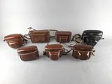 an image of a group of brown leather bags sitting on top of a table