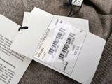 a label on a sweater with a price tag attached to it
