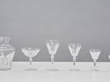 a group of wine glasses and a pitcher on a table