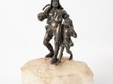 a statue of a man holding a child on a rock