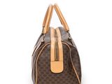 a brown and tan handbag on a white background