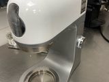 a white blender sitting on a counter in a kitchen