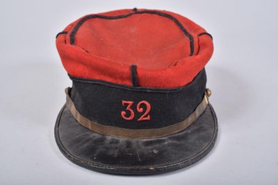 une image représentant un chapeau rouge et noir sur lequel figure le chiffre 32