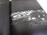 an open book with a picture of a city at night