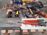 a pile of tools sitting on a pallet in a garage