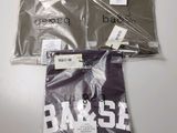three bags of clothing are sitting on a white surface