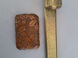 un petit morceau de bois posé à côté d'un briquet sur une table