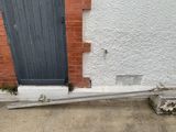 a black door and a brick wall next to a building